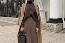 a monochromatic winter work look with a brown ribbed turtlenecksweater, a greige pleated midi, brown boots, a tan coat and a brown bucket bag