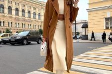 a neutral knit midi dress, a brown belt, white boots, a brown coat and a white bag for a super elegant look