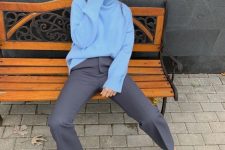 a simple and cool winter work look with a sky blue turtleneck sweater, grey trousers, black shoes and gold hoop earrings