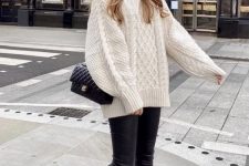 a simple winter work look with an oversized white patterned sweater, black leather leggings, black boots and a black bag
