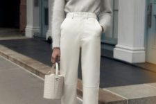 a total neutral outfit with a white mohair sweater, creamy cropped trousers, printed shoes and a white bucket bag