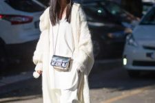 a total white look with a long top, culottes, a chunky knit long cardigan and neutral faux fur loafers plus a black bag