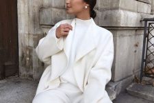 a total white winter work look with a turtleneck, trousers and a coat plus statement pearl earrings is wow