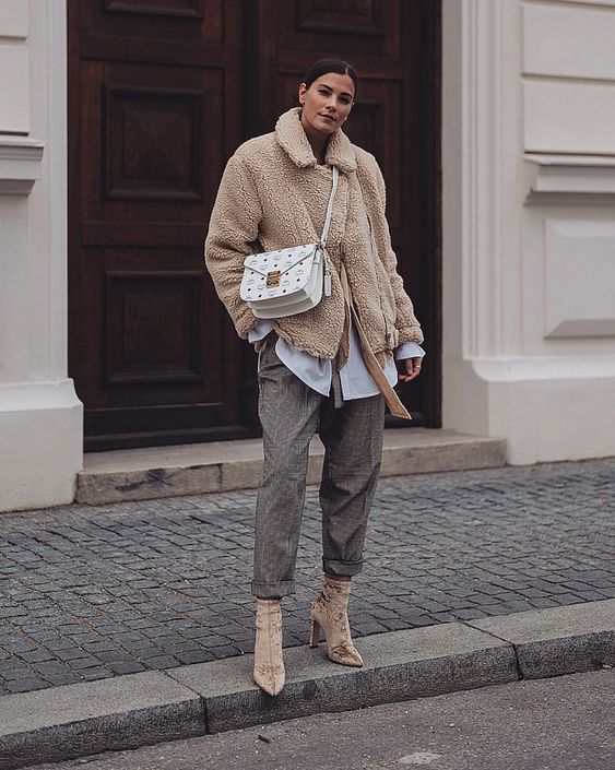 a white oversized shirt, grey plaid cropped trousers, tan velvet boots, a tan faux fur jacket and a white printed bag