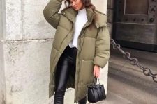 a white turtleneck, black leather leggings, black tall chunky combat boots, a green puffer coat, a black bag