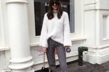 a white turtleneck sweater, plaid cropped trousers, black loafers, a black bag and a black cap for work