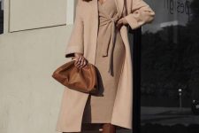 an elegant monochromatic winter work outfit with a knit wrap midi dress, a matching coat, brown boots and a clutch