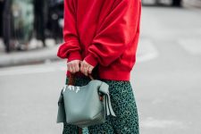 an oversized red sweatshirt, a green midi skirt, white boots and a light green bag for work