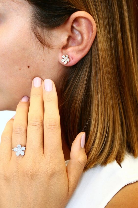 beautiful crystal flower studs and a matching rings to give a slight girlish touch to the look and make it more elegant and classy