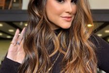 beautiful long dark brown hair illuminated with caramel blonde balayage for more dimension and texture is wow