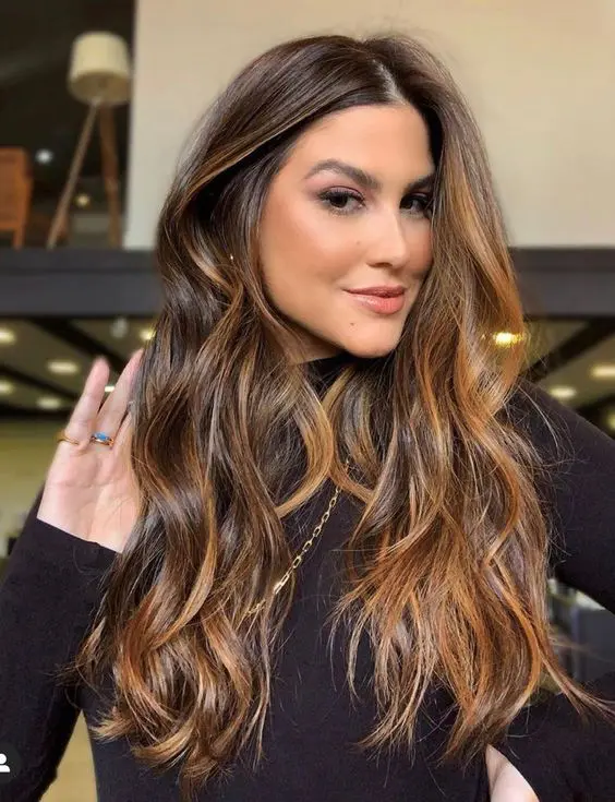 beautiful long dark brown hair illuminated with caramel blonde balayage for more dimension and texture is wow