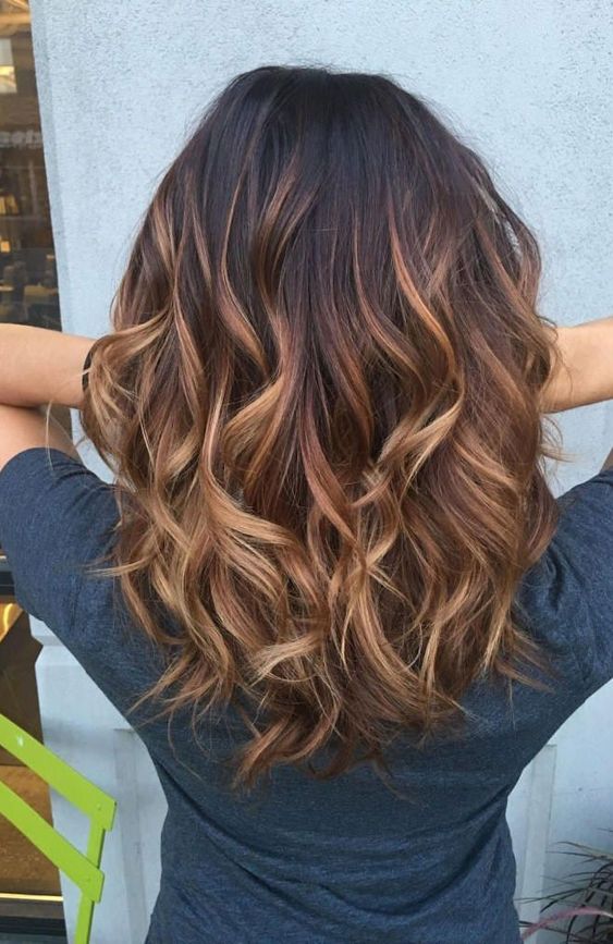 black hair with caramel and auburn balayage that brings much texture and dimension to the hairstyle will make you stand out