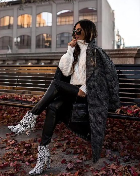 black leather leggings, an oversized white braided sweater, snakeskin booties, a grey plaid coat and a black bag
