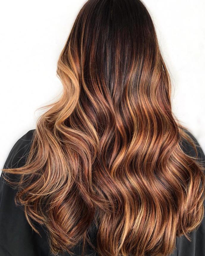 dark hair with sunset caramel highlights starting on the lower half to get an effortless transition