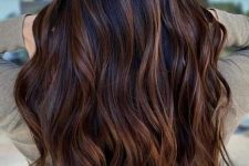 dark long wavy hair with caramel balayage is a gorgeous and chic way to give dimension to your super long hair