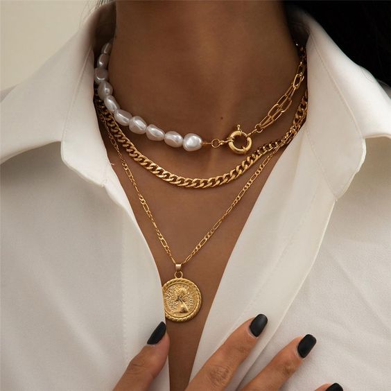 gorgeous layered necklaces   a gold chain and baroque pearl one, a chunky and a delicate chain with a coin