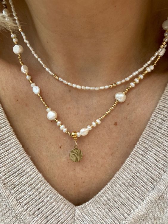 layered necklaces -  a seed pearl one with gold beads and a regular and irregular pearl one with a coin for a trendy look