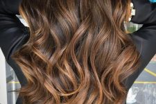 long dark wavy hair with lovely caramel highlights that give texture and dimension to the hairstyle and make it amazing