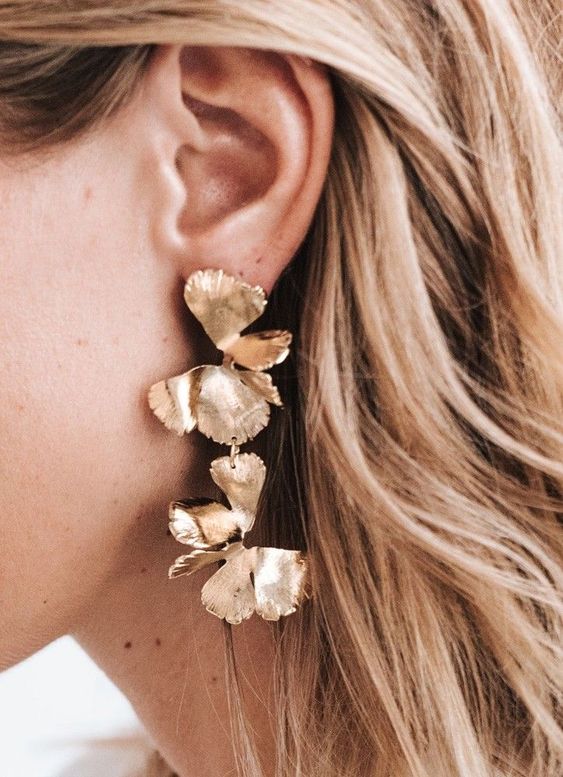 lovely gold flower cascading earrings are a bold statement for a modern look at a party or for some special occasion