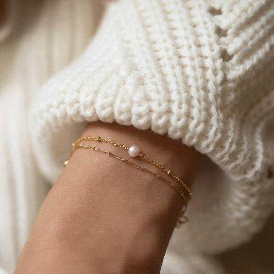 pair your delicate gold pearl bracelet with knits for a contrast and a very elegant touch to your outfit that wows
