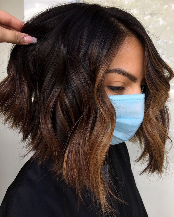 very dark brown hair - a short wavy bob with caramel balayage and a butterscotch face frame for a bolder look