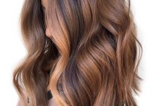 very dark brown hair accented with caramel and honey blonde balayage including money pieces to accent the face more