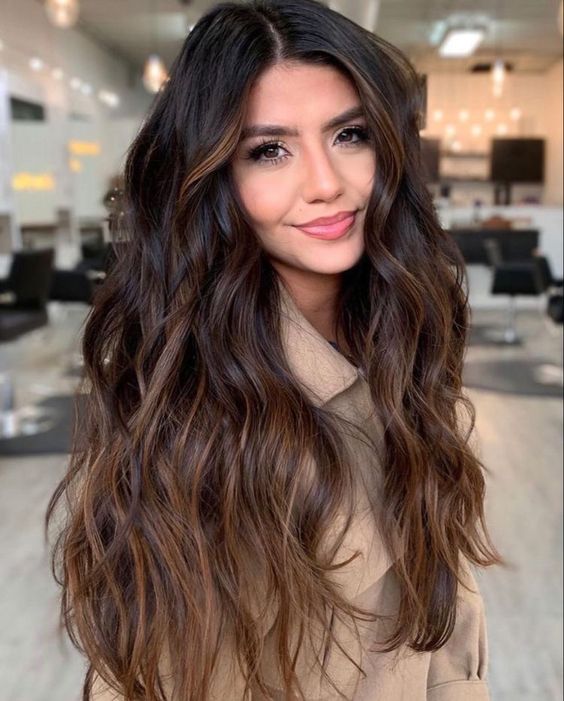 very dark brown hair with caramel and chestnut balayage gives a bold and catchy touch to the look