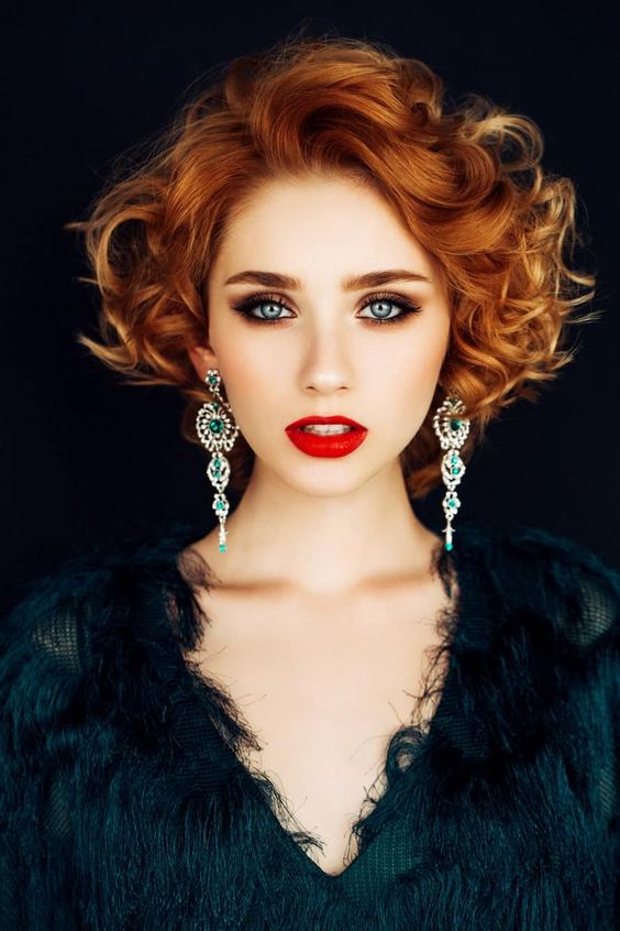 short ginger hair in curls showing off statement earrings is amazing for a party and looks jaw-dropping