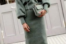 04 a beautiful and comfy outfit with a knit green hoodie and a matching midi skirt, a matching green bag and brown boots