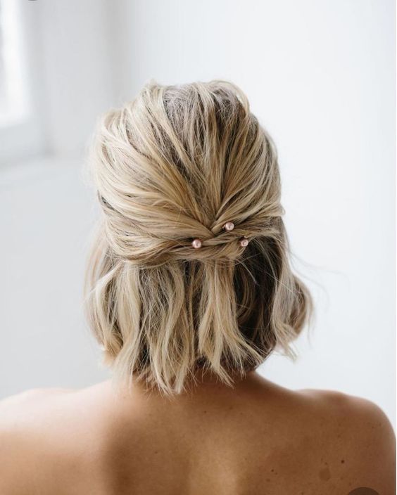 short textural and wavy hair done into a half updo with blush pearl hairpins is a lovely idea thta won't take much effort