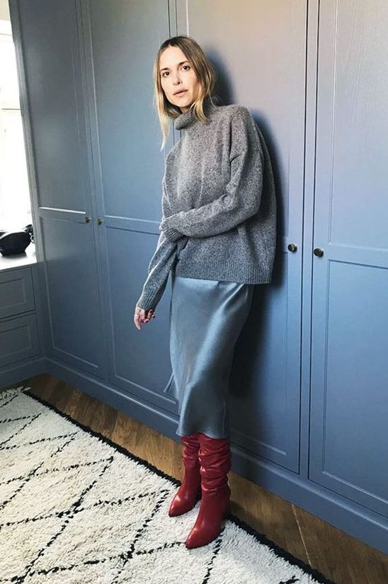 an oversized grey sweater, a blue slip dress and red boots for a bold and colorful winter look