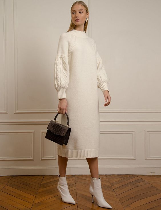 a gorgeous creamy midi sweater dress with long patterned sleeves, a high neckline, white booties and a black bag for an elegant look