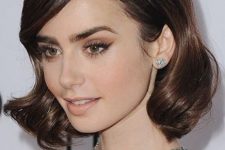 09 Lily Collins rocking a retro-inspired wavy hairstyle with a touch of gloss and creative parting for a super elegant look