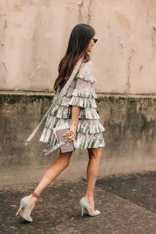 a silver tiered mini dress with light green sequin ruffles, seafoam shoes and a neutral clutch for the holidays