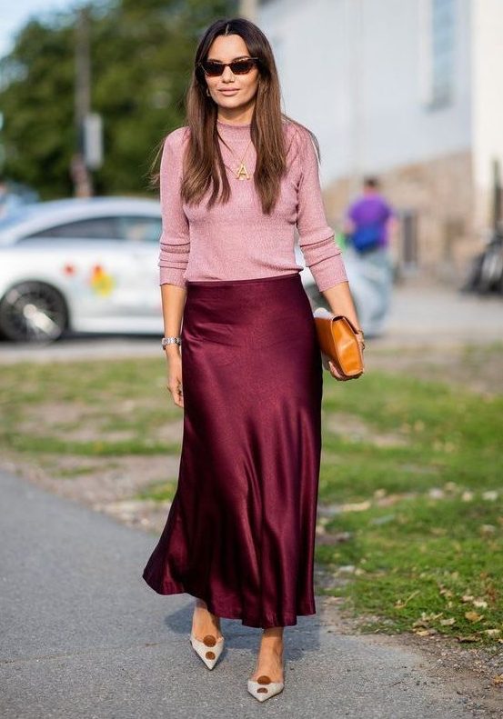 a burgundy slip skirt, a pink top, a brown clutch and two tone shoes for a spring or fall look