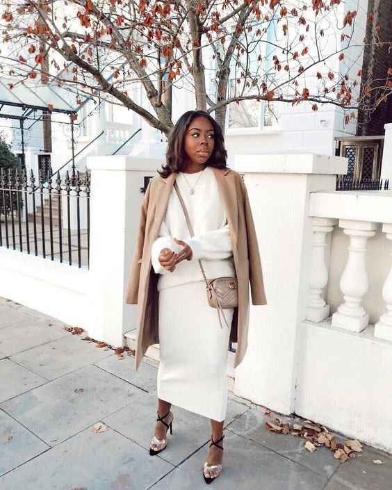 a gorgeous and luxurious look with a creamy co-ord set with a midi skirt and a jumper, a tan coat, lace up shoes and a tan bag