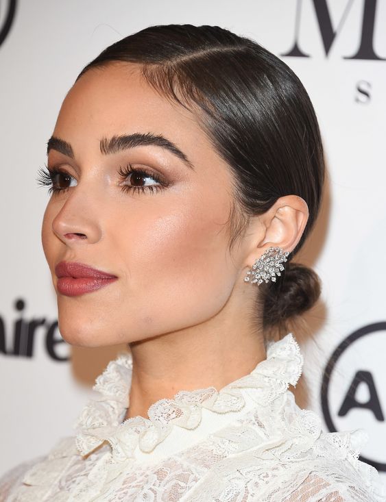 a small low bun with a super sleek top and side parting is a pretty formal and catchy idea that is extremely elegant