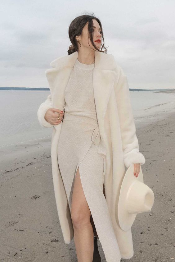 a jaw-dropping winter look with a creamy jumper and wrap skirt co-ord, a matching faux fur coat and a hat