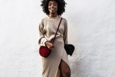 15 a lovely neutral knit co-ord set with a jumper, a wrap midi skirt, black heels and a burgundy velvet bag
