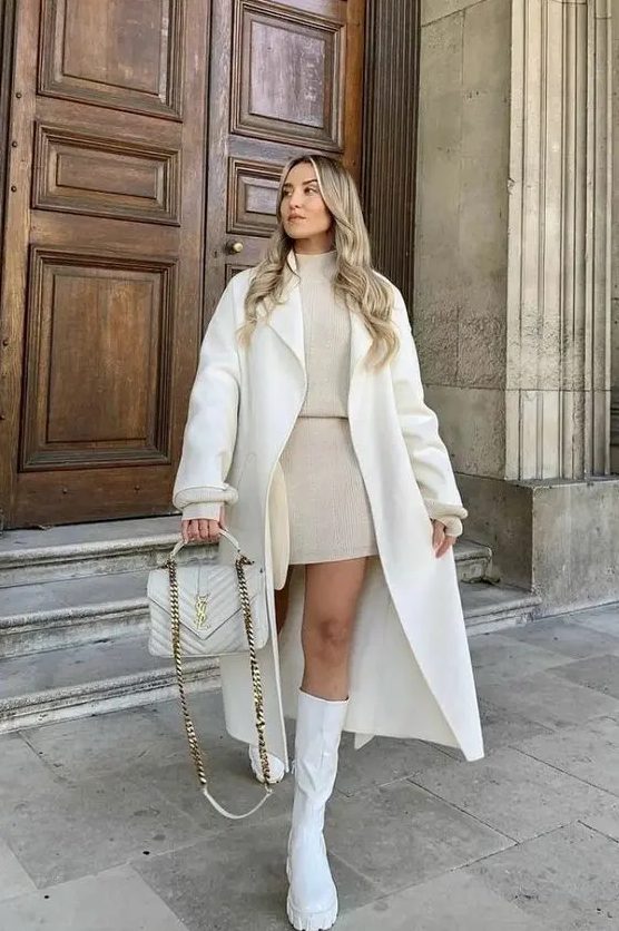 a neutral winter outfit with a tan knit suit - a turtleneck and a mini skirt, a creamy coat and a bag, white boots