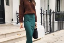 17 a fall work outfit with a brown jumper, a green slip midi skirt, brown boots and a black bag