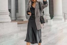 18 a fall work outfit with a black slip midi dress, a grey plaid oversized blazer, black boots and a bag