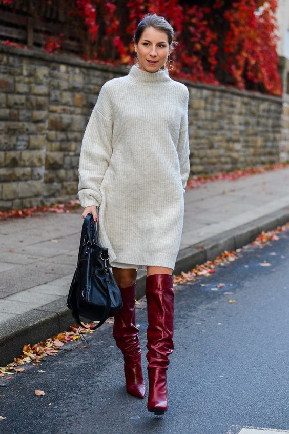 a neutral sweater mini dress, red knee boots, a black bag plus statement earrings for the holidays