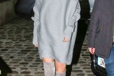 21 a trendy oversized grey sweater dress with long sleeves, grey suede over the knee boots – just add statement earrings and go