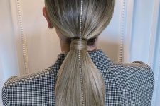 22 a glam take on a classic low ponytail with a shiny rhinestone strand is a lovely idea for the holidays