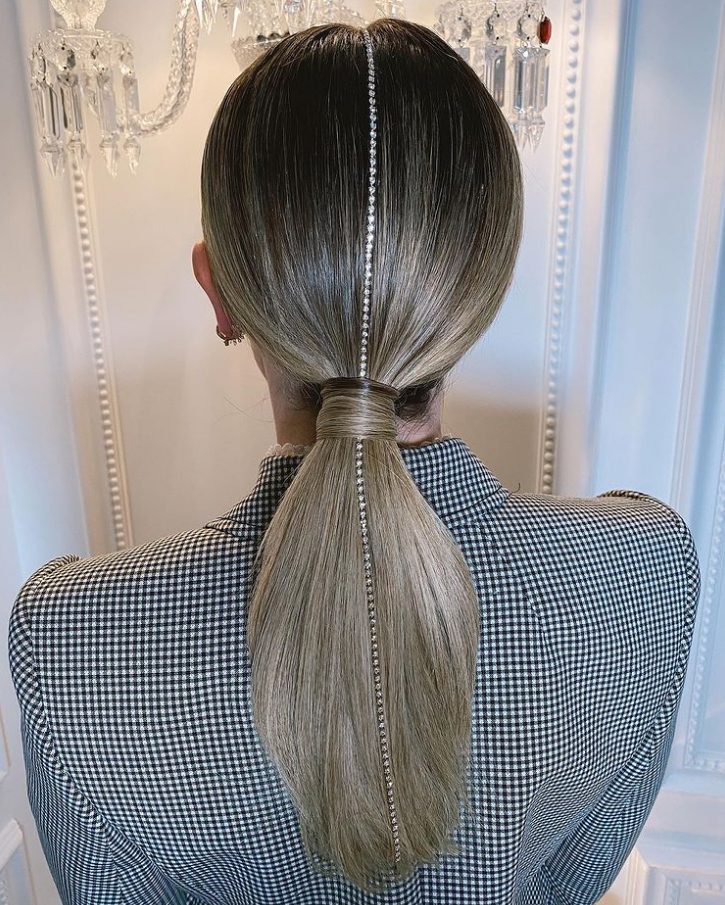 a glam take on a classic low ponytail with a shiny rhinestone strand is a lovely idea for the holidays
