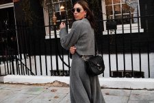 22 a winter look with a grey jumper and an A-line midi skirt, white trainers and a black bag