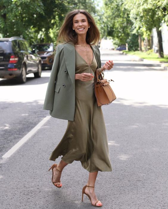 a fall work look with an olive green slip midi dress, a green blazer, nude shoes, a tan tote is chic