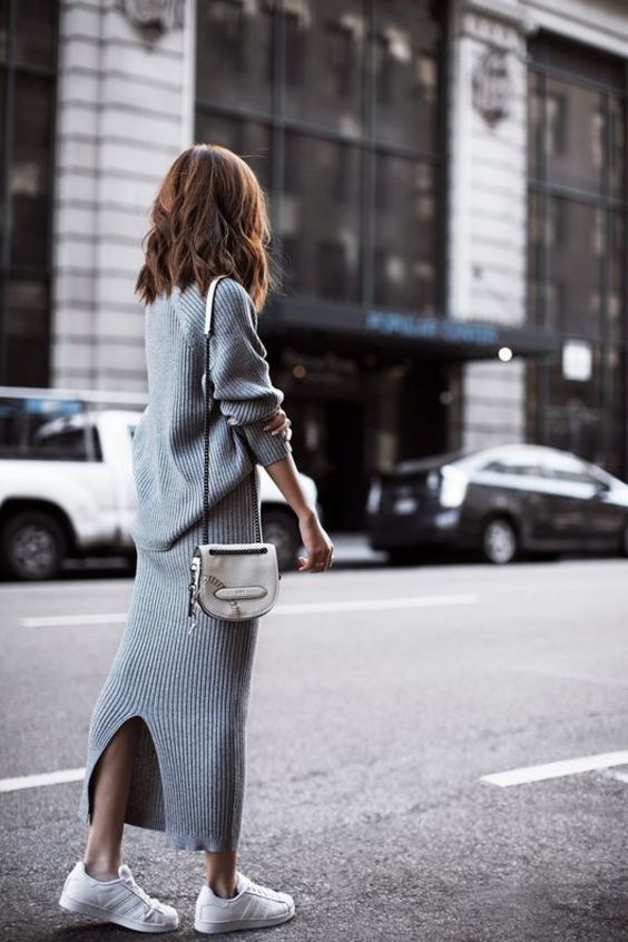 a simple and pretty grey ribbed knit co-ord with a back slit on the skirt and an oversized sweater, white sneakers and a white bag