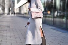 24 a white knit midi dress with a side slit and a turtleneck, grey wide knee boots and a pink bag